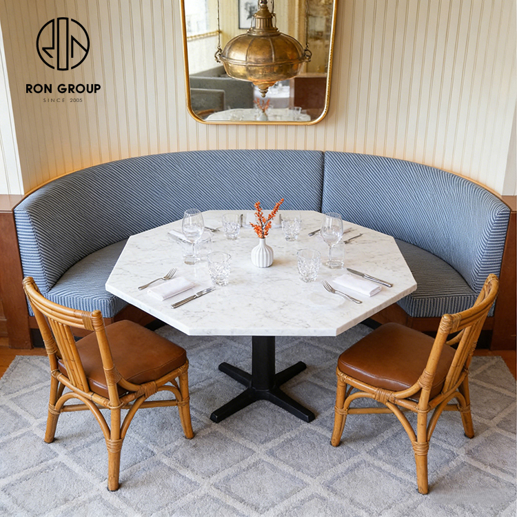 Custom Curved Booth Seating with Octagonal Stone Table for Space-Efficient Dining